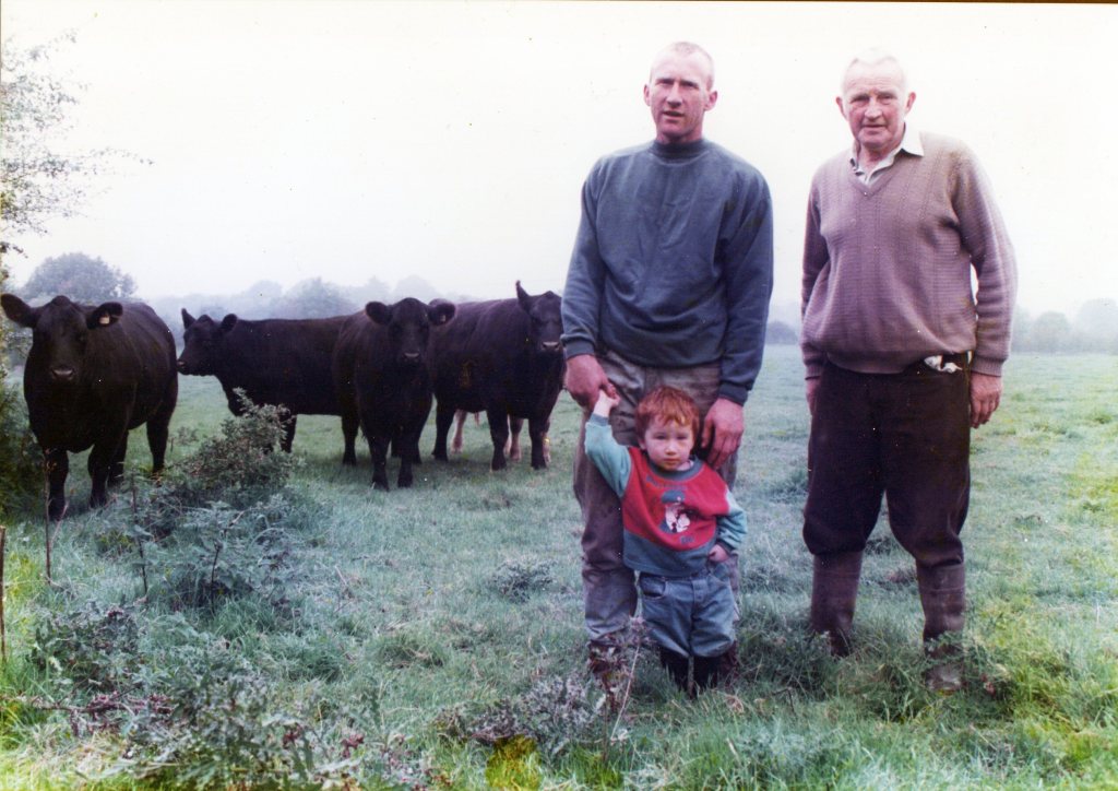 Three generations of McEnroes with Angus cattle